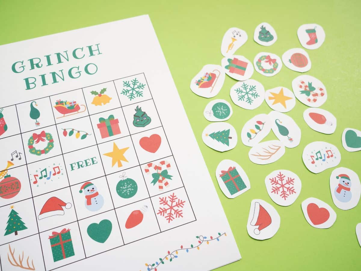 grinch bingo card printed with all the caller items cut out on table