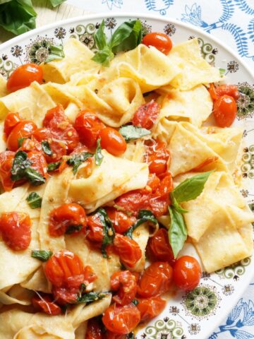 platter of homemade pappardelle with cherry tomato sauce on plate