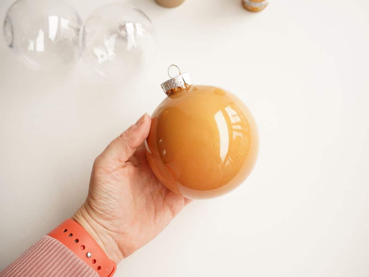 brown paint coated inside a clear fillable christmas ornament