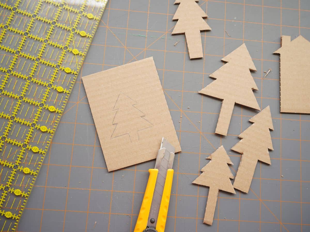 cardboard trees cut out with utility knife and ruler on self healing mat