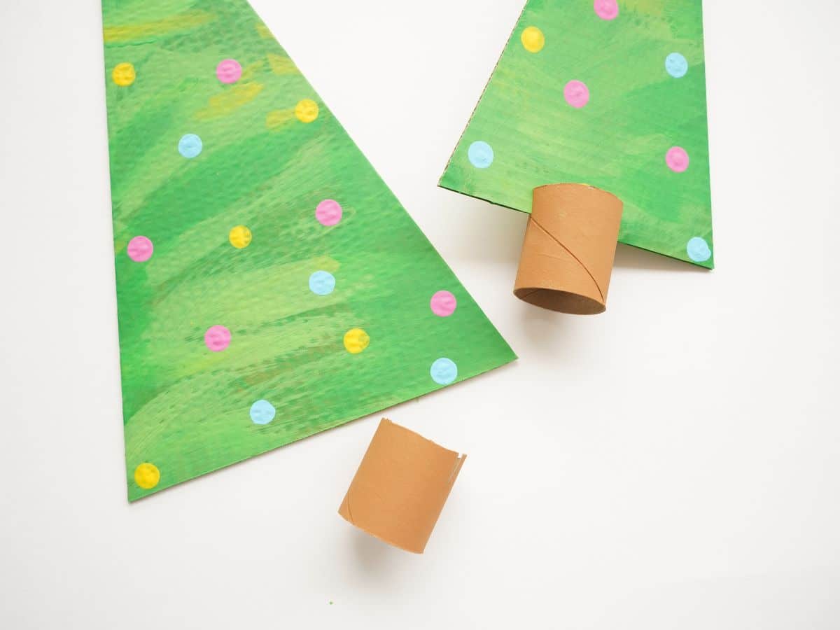 cardboard trees slotted into toilet paper roll christmas tree trunks