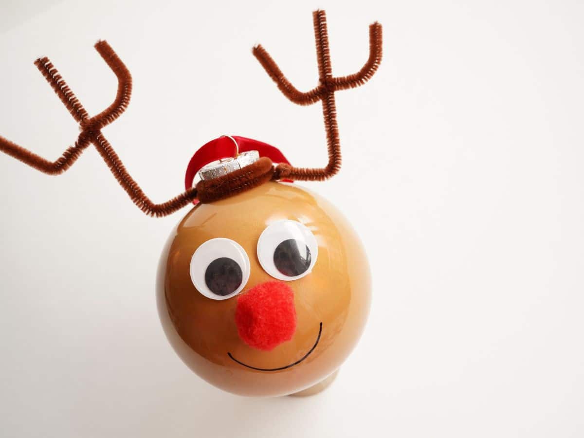 final reindeer ornament with pipe cleaner antlers on white background