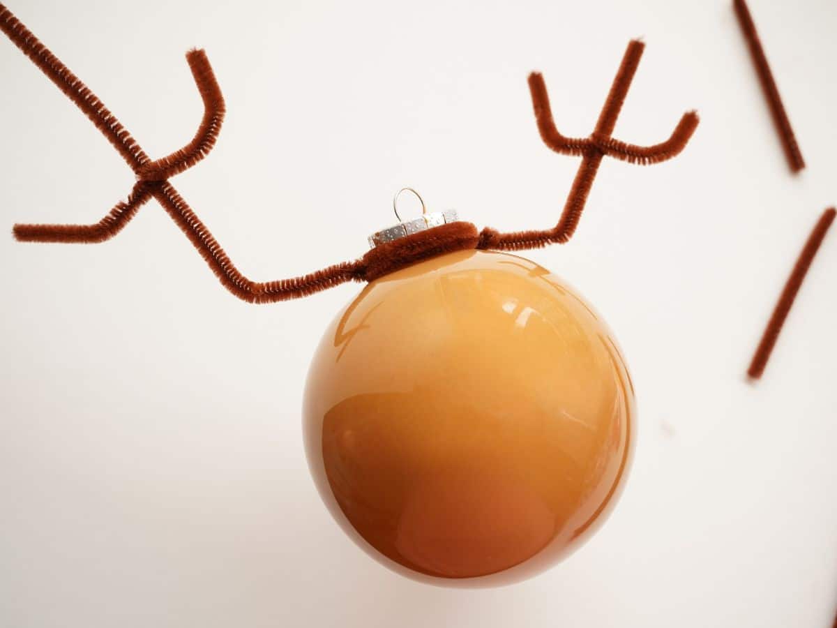 pipe cleaner reindeer antlers wrapped on top of ornament