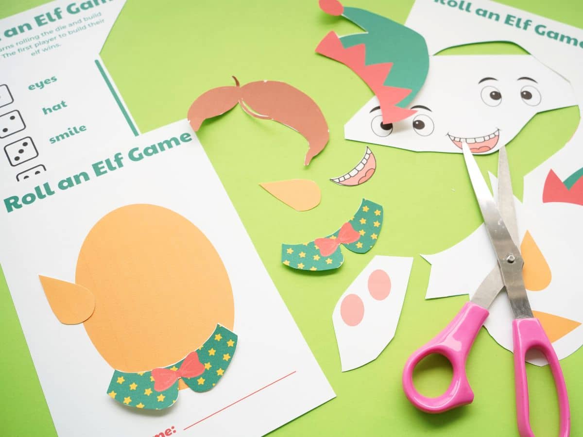 pieces of roll an elf game cut out with scissors on table