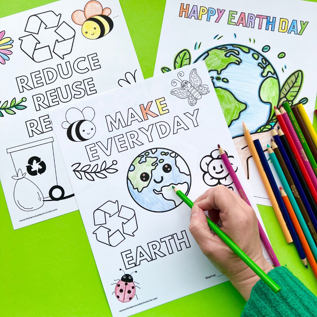 3 print outs of earth day coloring pages with person's hand and pencil crayons