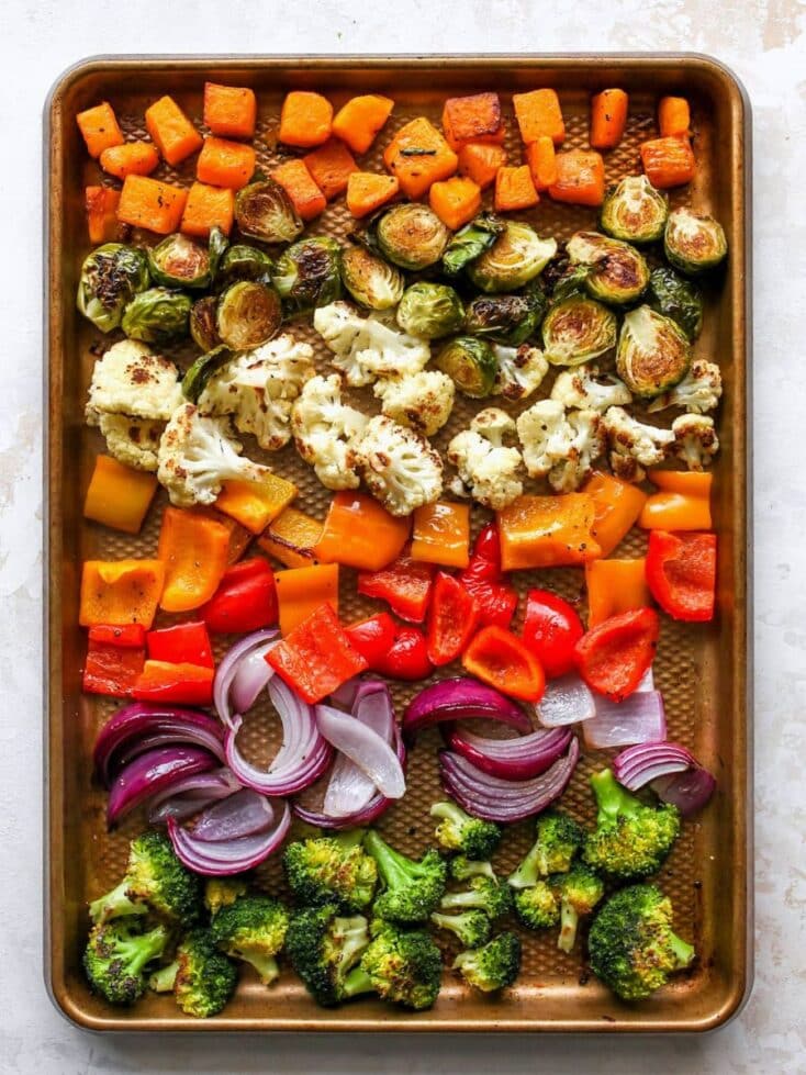 baking sheet with roasted vegetables broccoli, cauliflower, peppers, onions and sweet potatoes