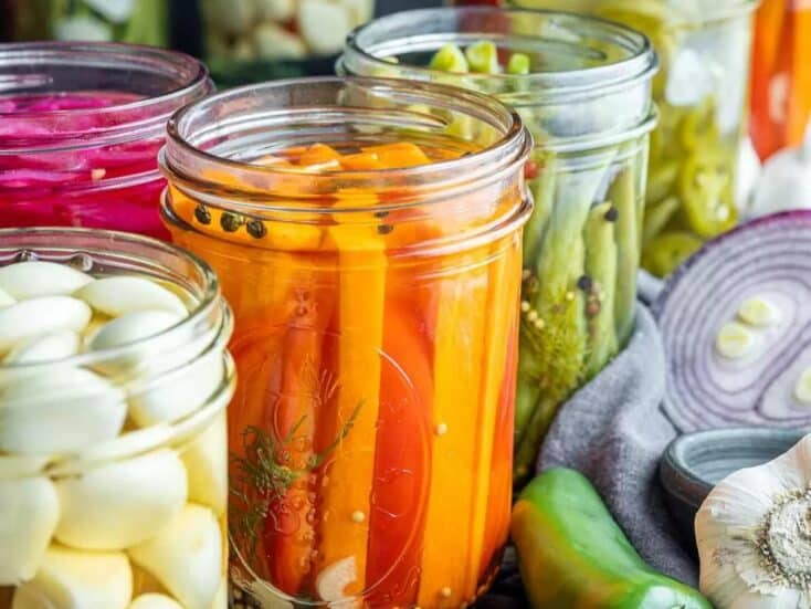 pickled vegetables carrots, onions and green beans in mason jars