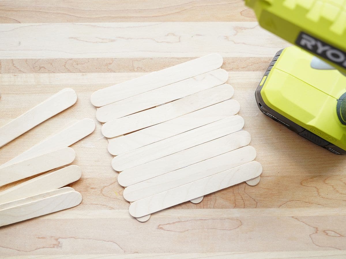 base of popsicle stick bird feeder made with glue gun