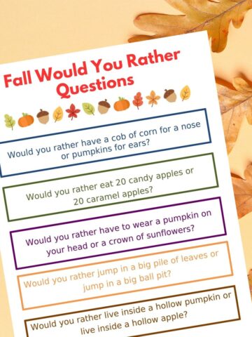 fall would you rather questions printed and surrounded by fall leaves featured image