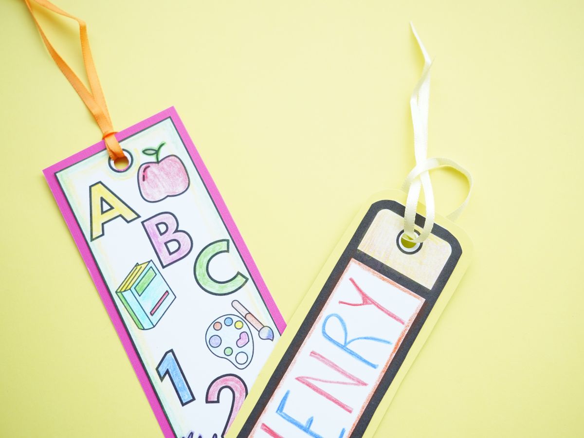 Top of 2 printable bookmarks with ribbon fed through the top hole