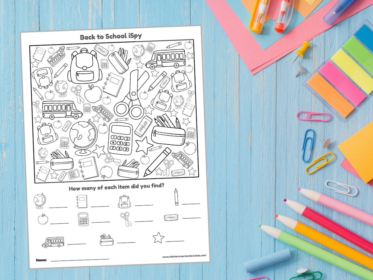 image of printable back to school ispy game to color on desktop surrounded by school supplies