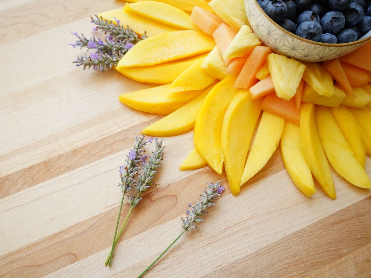 sprigs of lavender beside mango slices