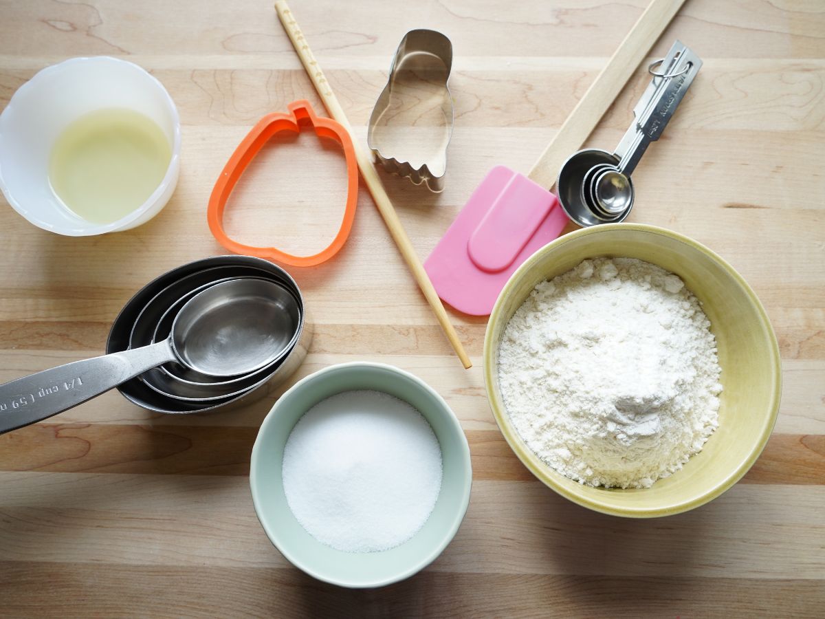 ingredients for salt dough recipe - flour in bowl, salt in bowl, vegetable oil in bowl measuring spoons