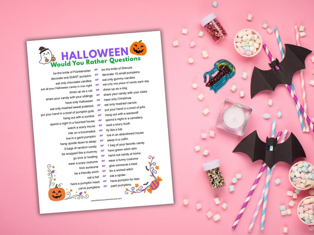 paper bats and candy with a print out of Halloween would you rather questions for kids