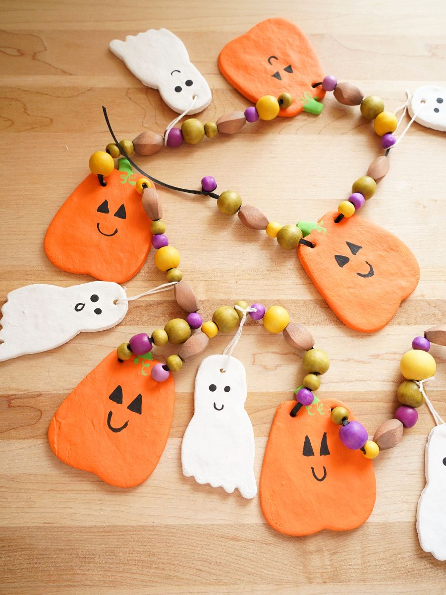 salt dough pumpkin and ghost garland laying table