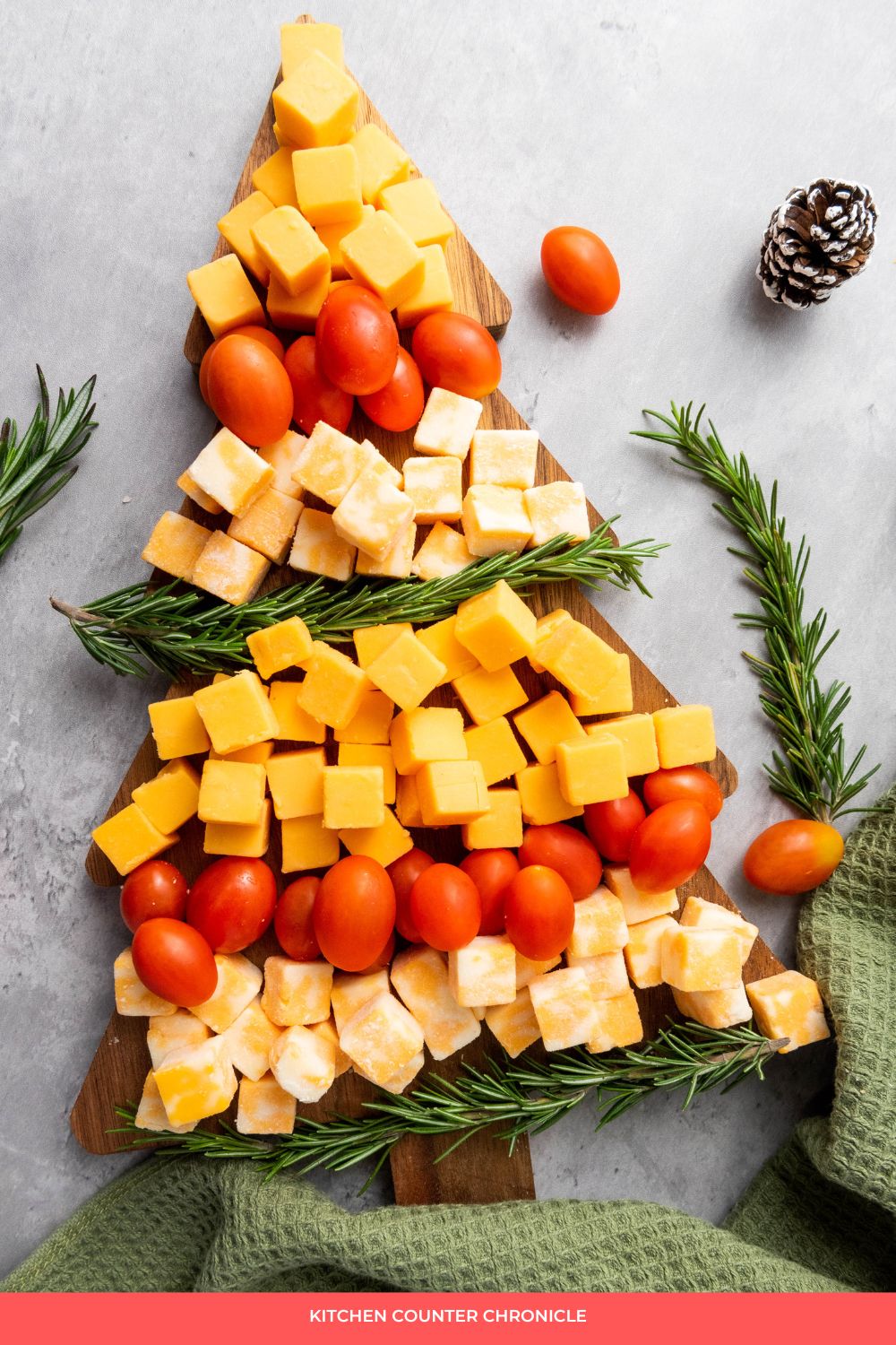 Easy Christmas tree cheese platter - with cheese, cherry tomatoes and rosemary on a christmas tree shaped board