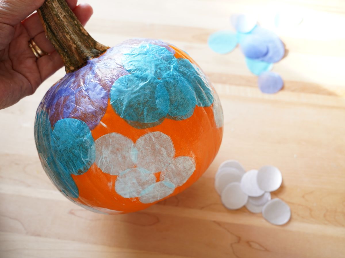 blue tissue paper dots decoupaged onto small pumpkin