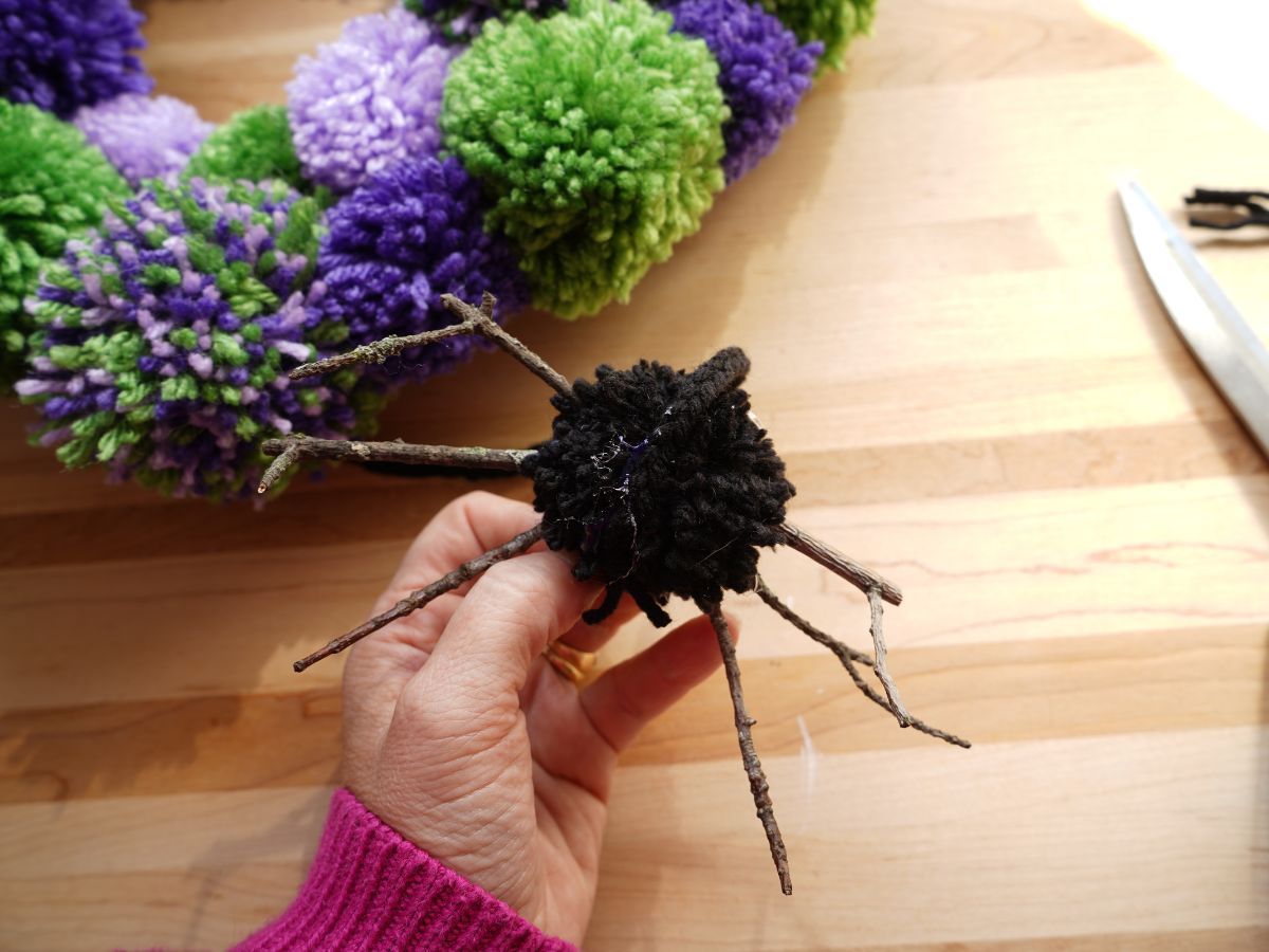 braided black yarn with pom pom spider glued on