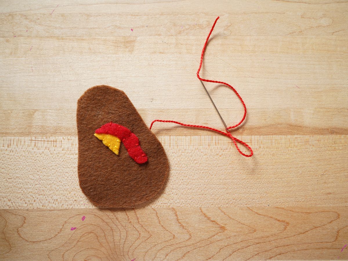 felt turkey beak and wattle sewn on body with needle