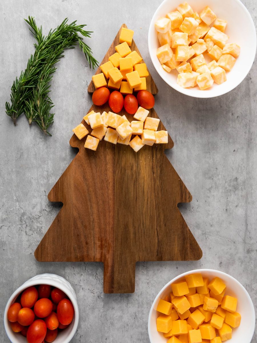 layer of colby cheese cubes on christmas tree shaped cheese platter