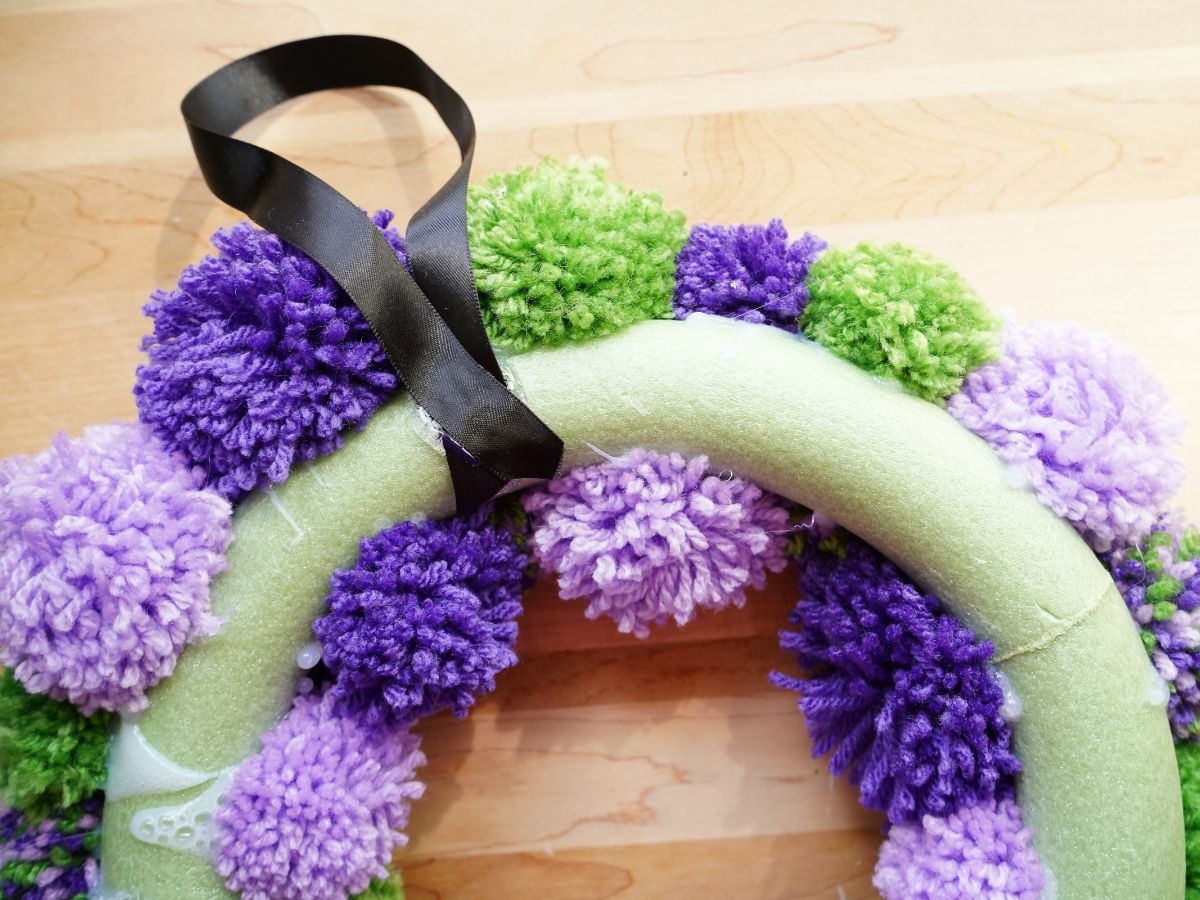 loop of black ribbon on back of diy halloween wreath