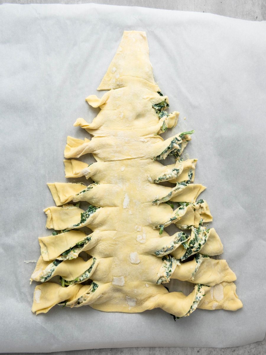 puff pastry christmas tree unbaked with the branches twisted
