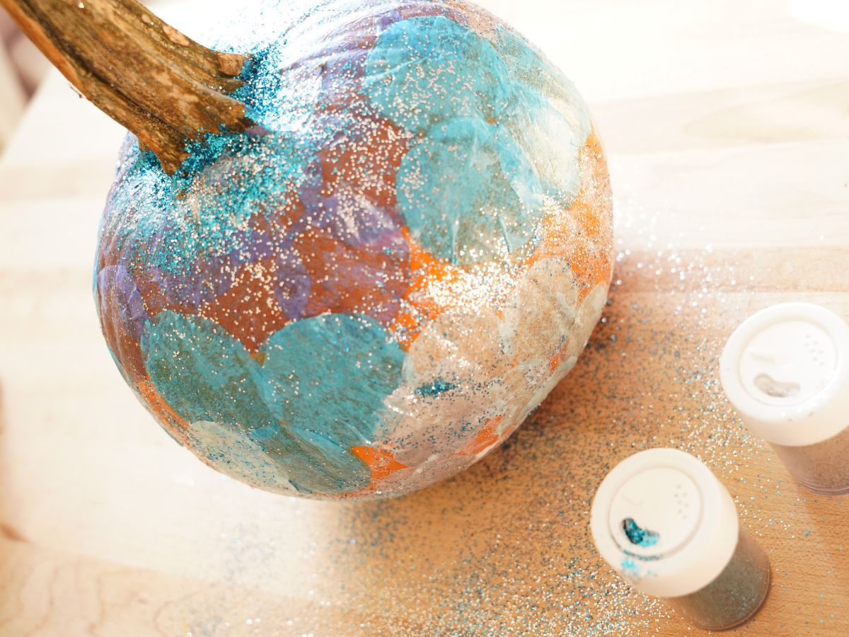 small pumpkin with silver glitter and blue tissue paper dots decoupaged on