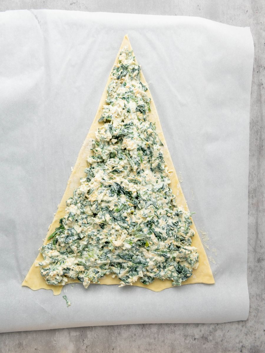 spinach dip filling spread on christmas tree triangle of puff pastry