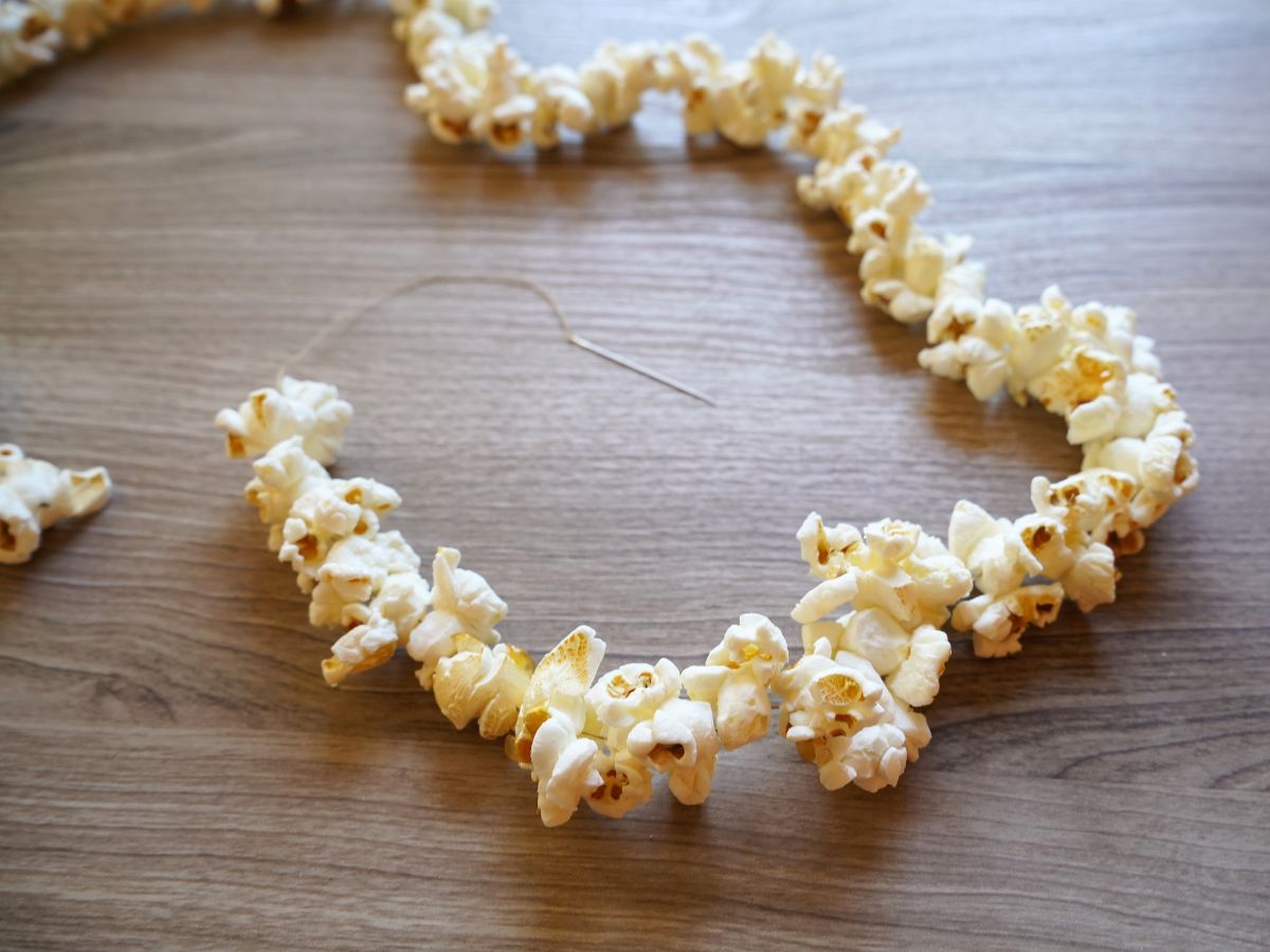 close up of popcorn garland with needle and thread at the end of the garland