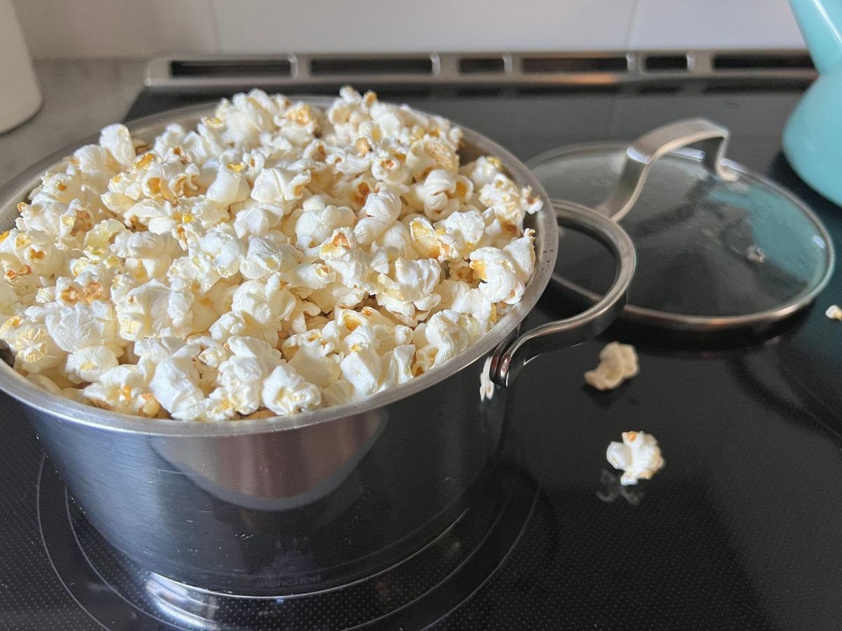 pot on stove filled with freshly popped popcorn