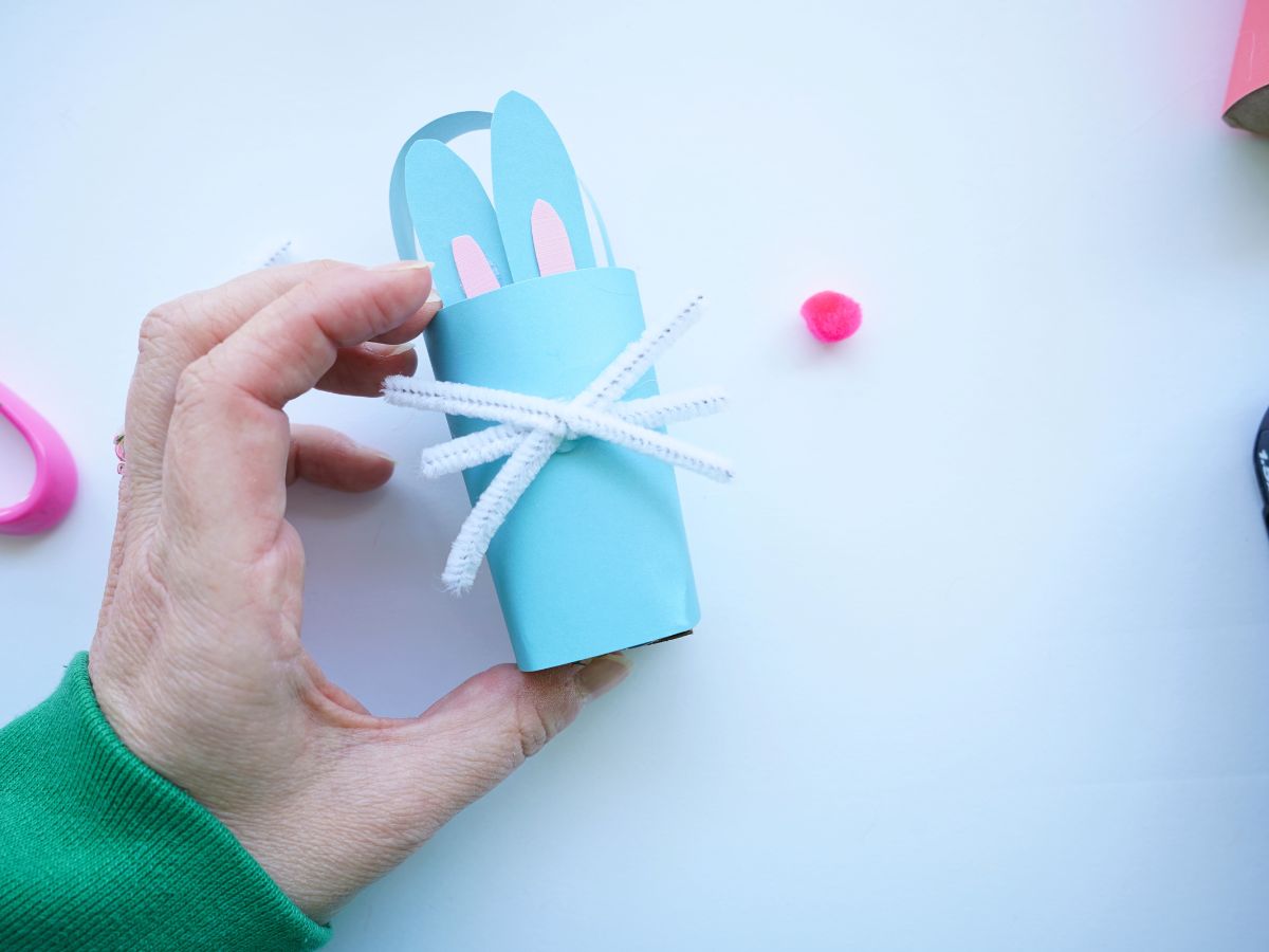 easter bunny basket with pipe cleaner whiskers being held in woman's hand