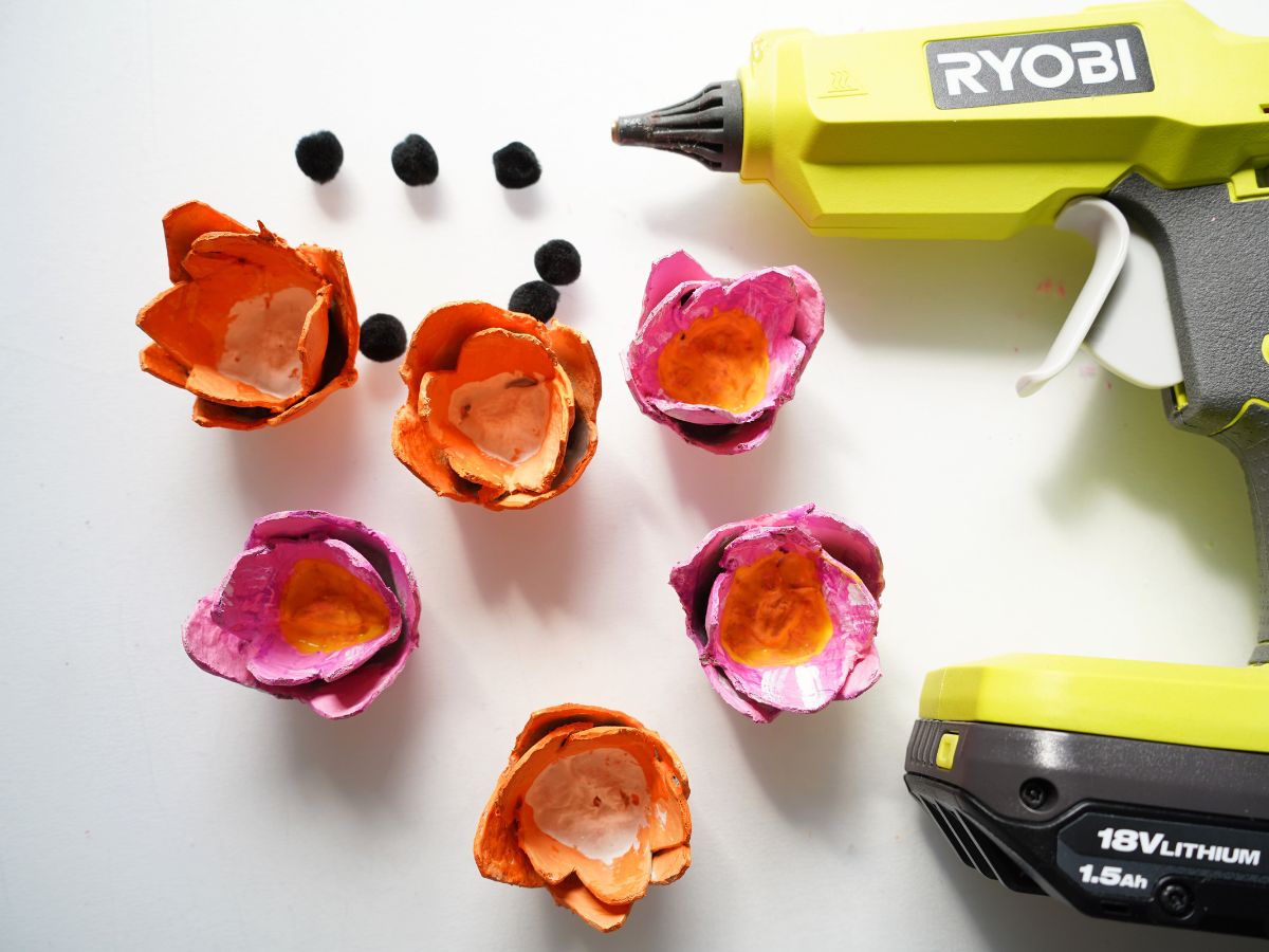 egg carton tulips painted with black pompoms and glue gun