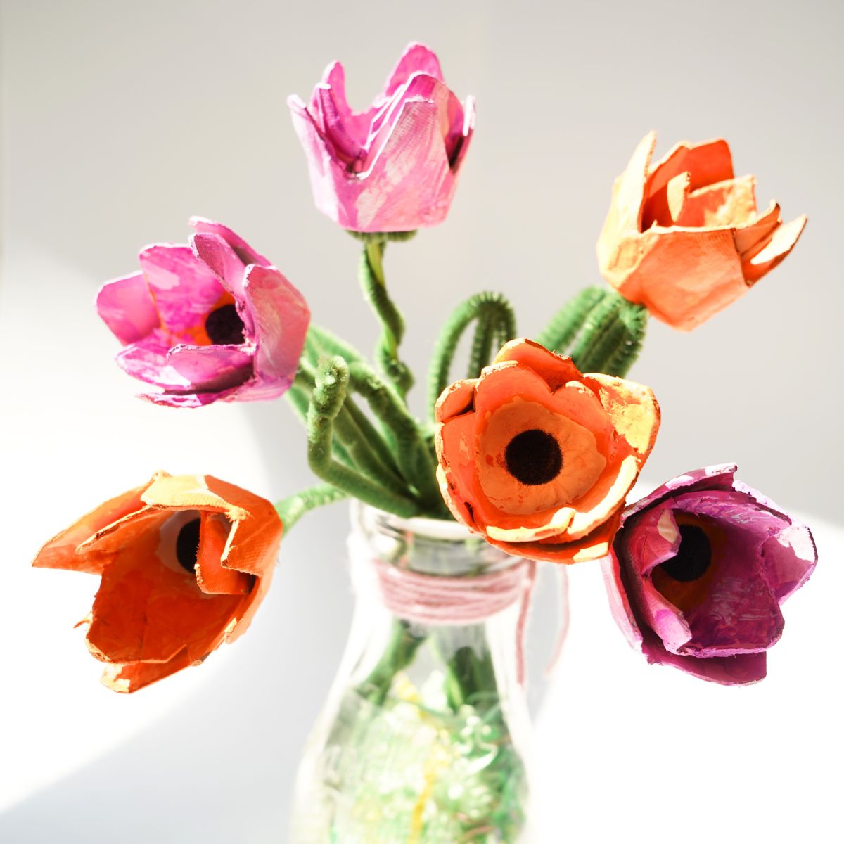 vase filled with pink and orange egg carton tulips featured image