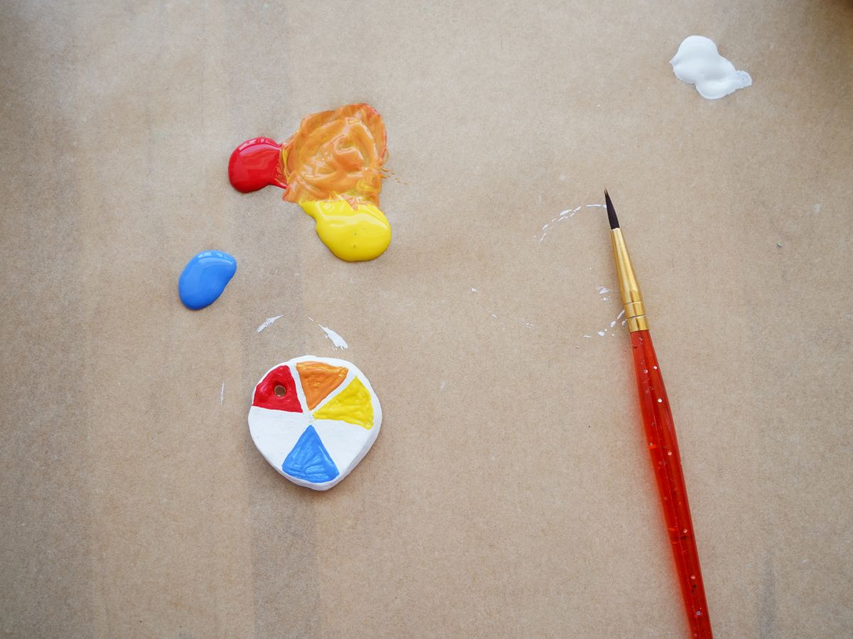 air dry color wheel pendant with mixed primary acrylic paints and yellow, orange, blue, red sections painted