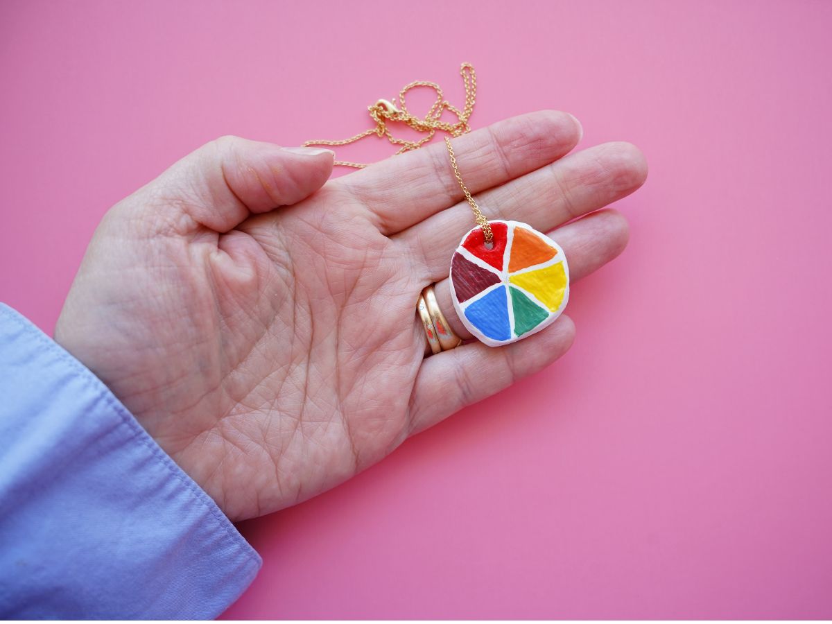 diy color wheel necklace with gold chain in woman's hand