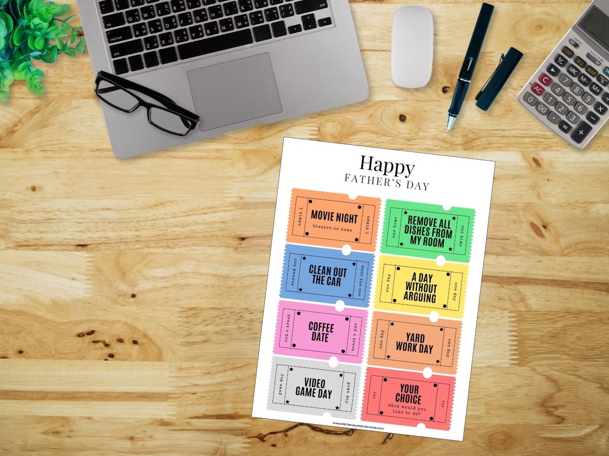 father's day coupons printed out and on desktop with desk supplies
