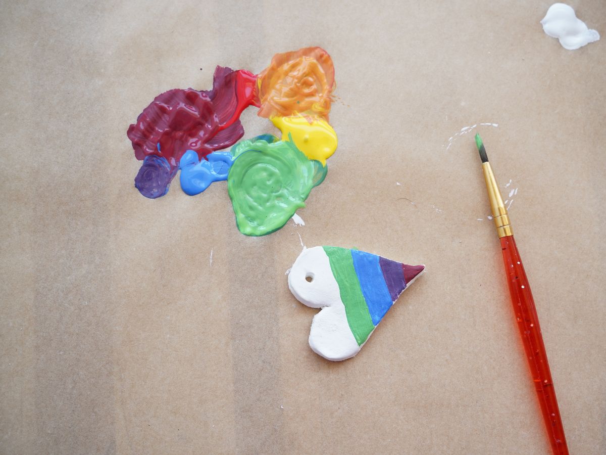 green and blue rainbow stripes painted on diy heart pendant