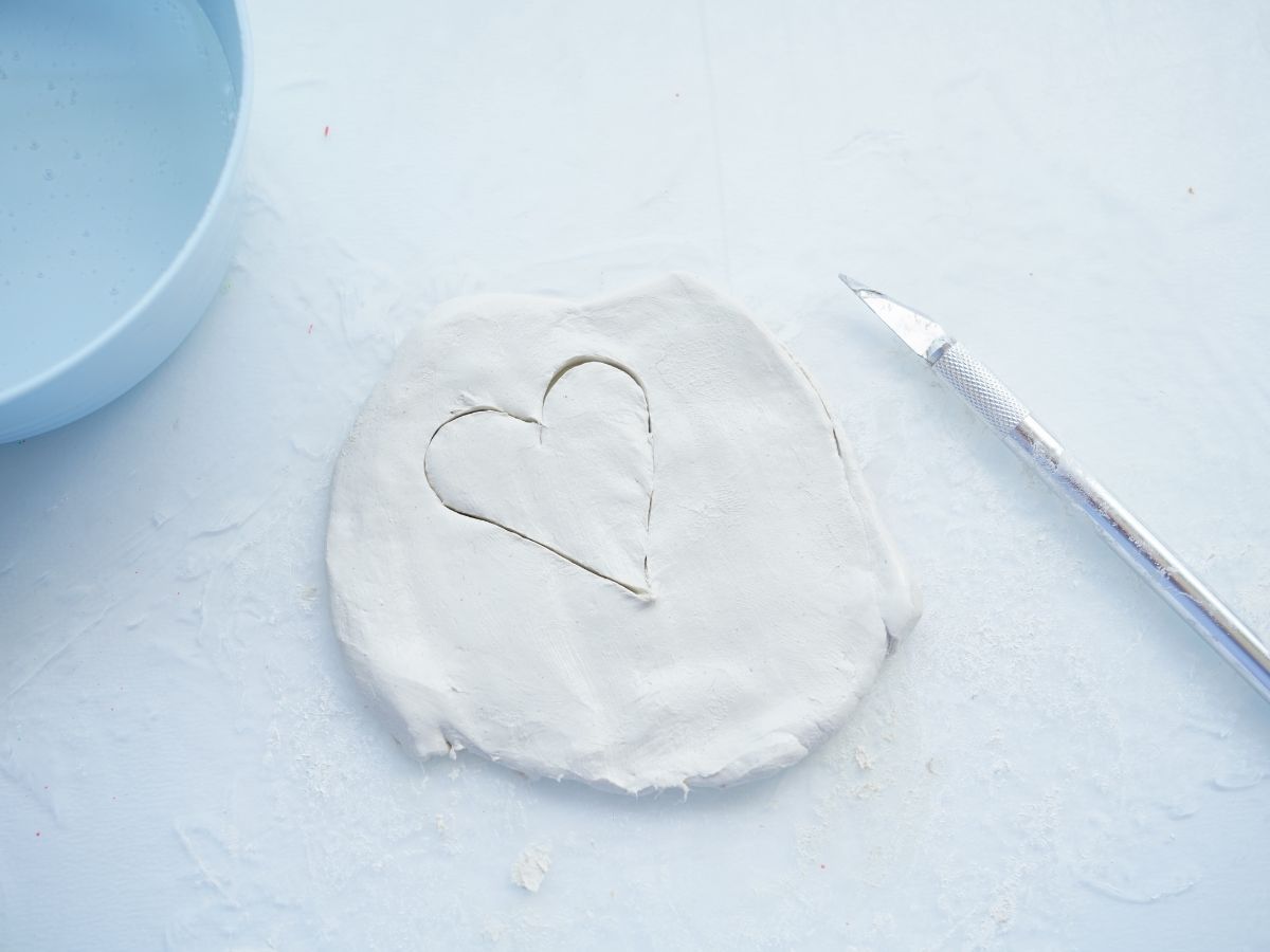 heart cut into air dry clay with utility knife