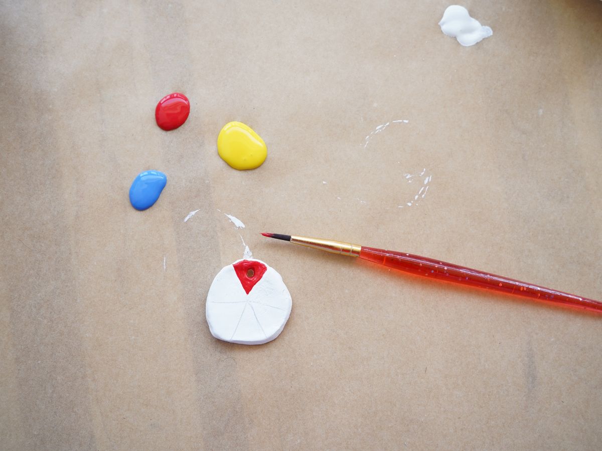 red section painted on color wheel pendant with red, yellow and blue blobs of paint