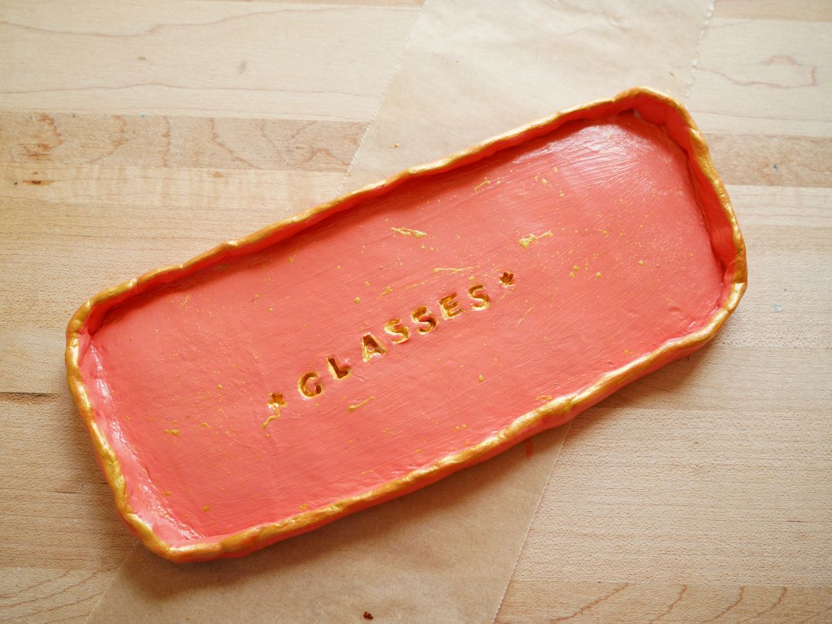 coral and gold painted glasses tray on table