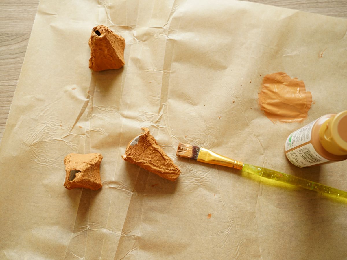 3 egg carton ice cream cones painted brown with paintbrush and paint