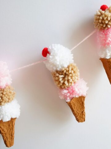 3 egg carton ice cream cones with pom pom ice cream and cherry on top garland