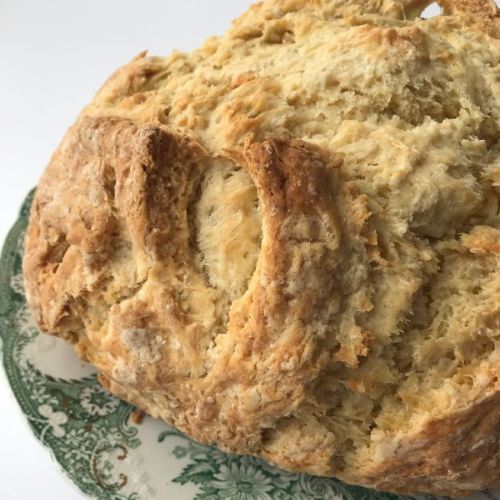 loaf of Irish soda bread on a green plate