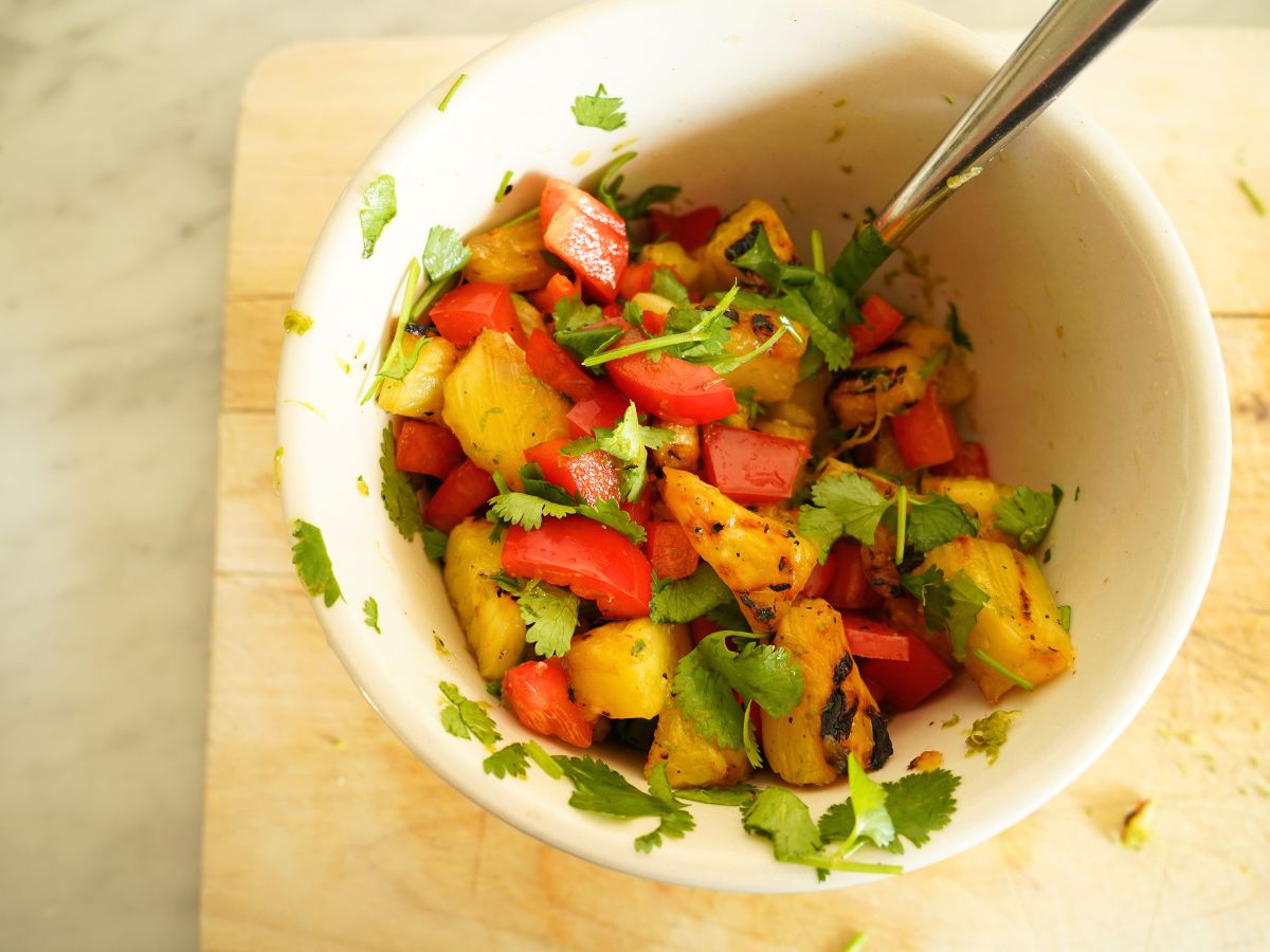 bowl of pineapple salsa with spoon in bowl