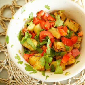 close up of bowl filled with pineapple and red pepper salsa