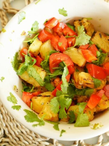 close up of bowl filled with pineapple and red pepper salsa