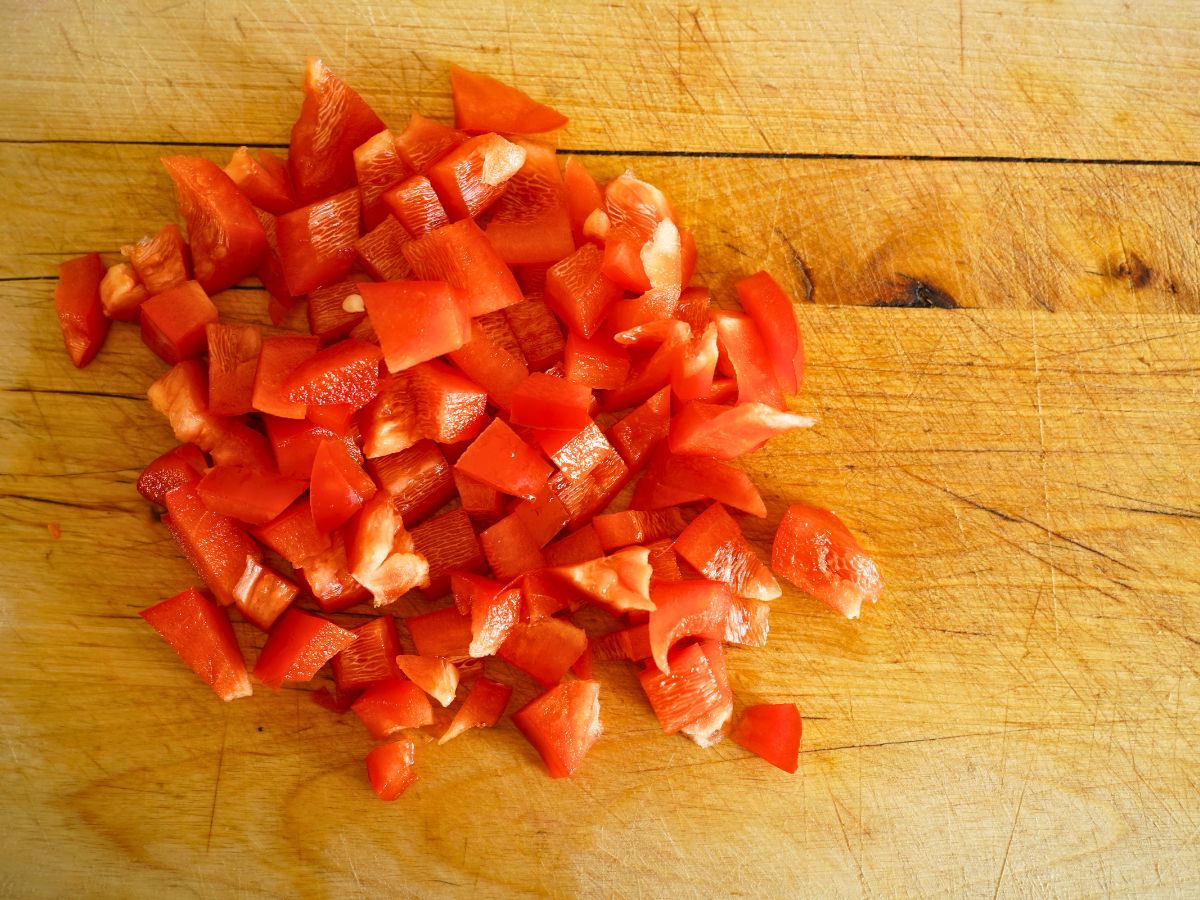pile of sweet red pepper diced on cutting board