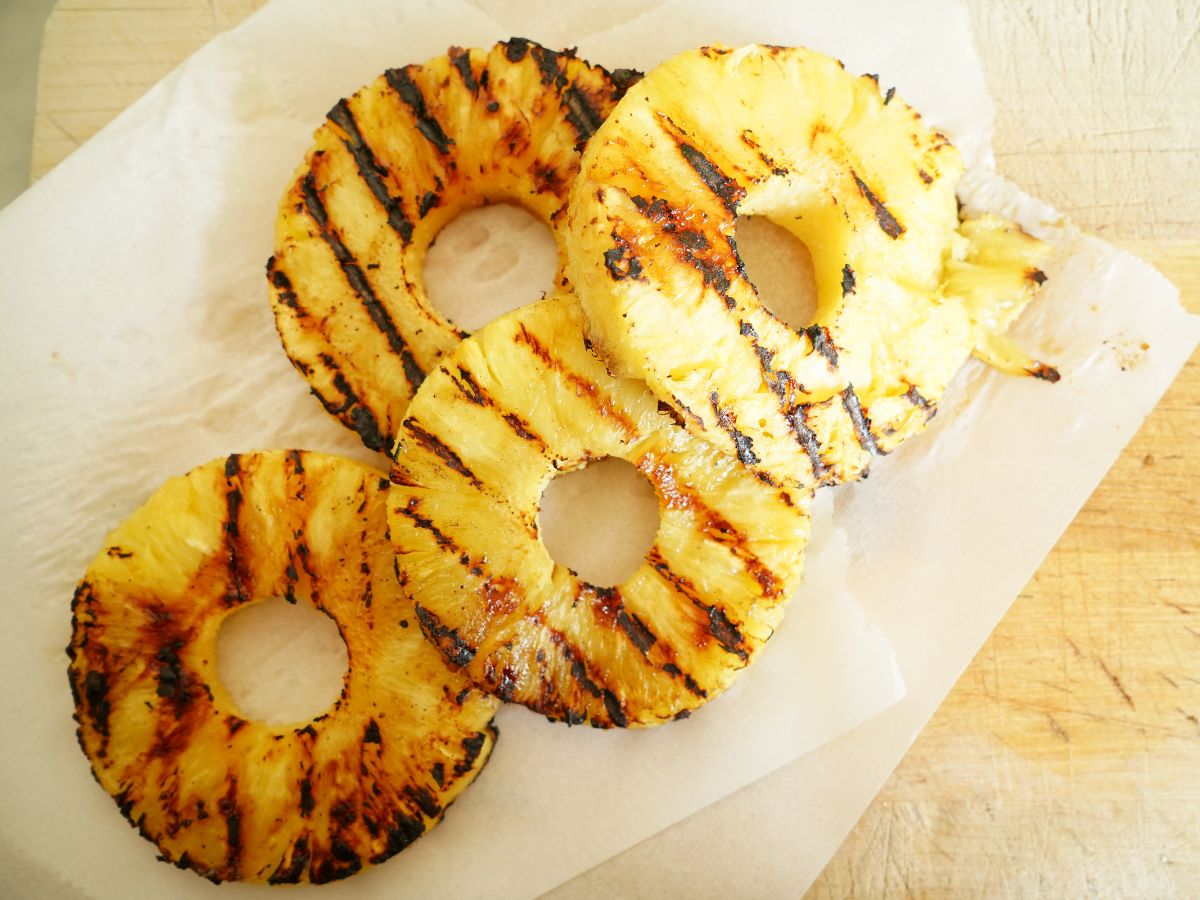 slices of grilled pineapple on cutting board
