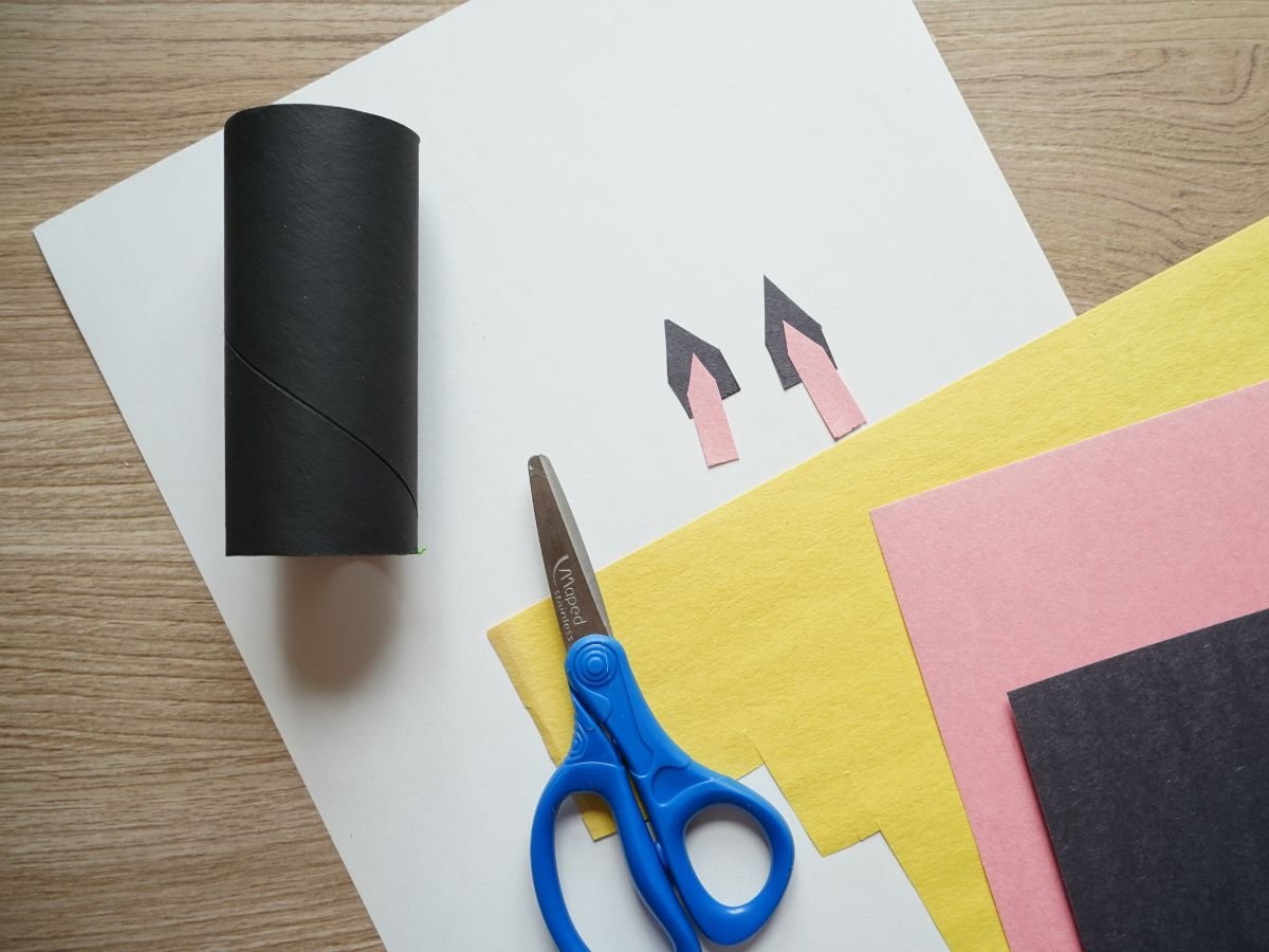black toilet roll with cat ears cut from construction paper