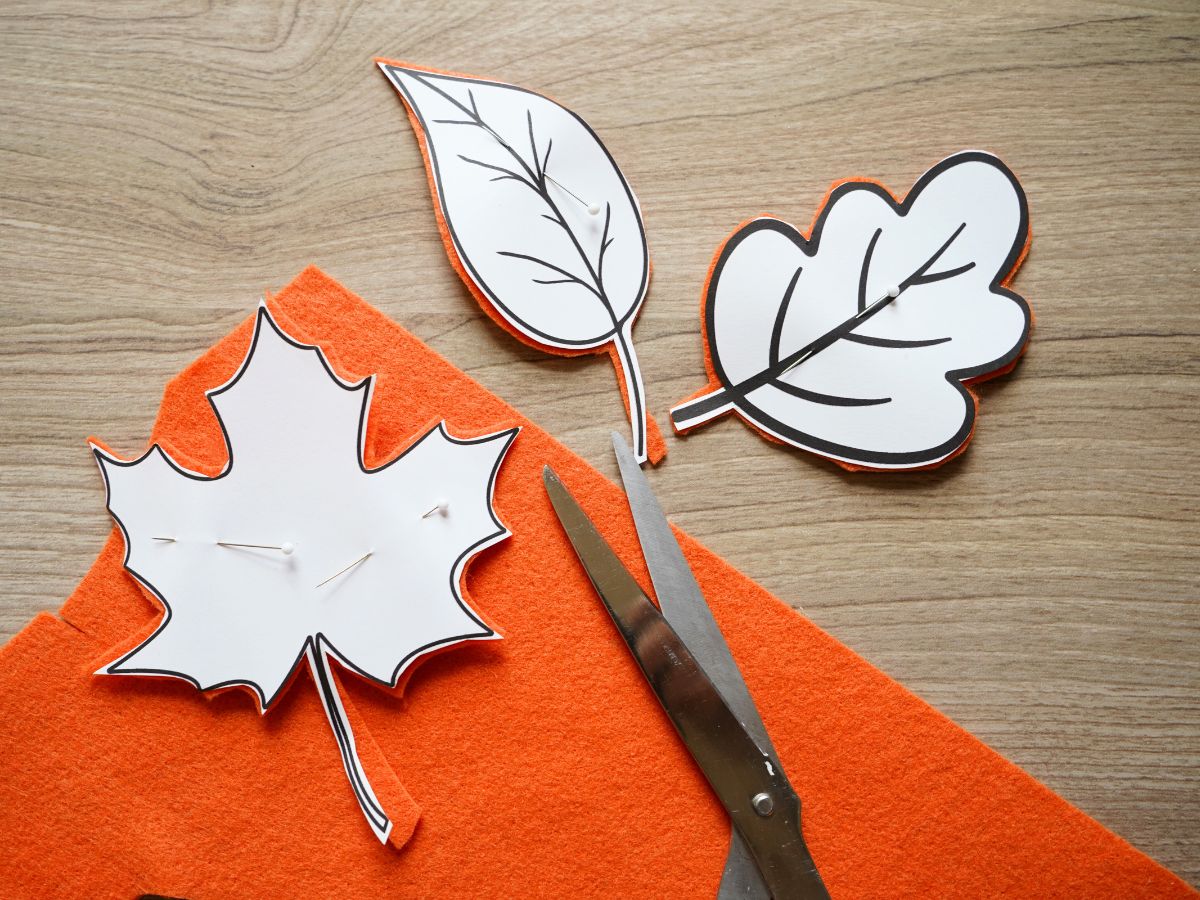 fall felt leaves with template pinned to felt and cut out